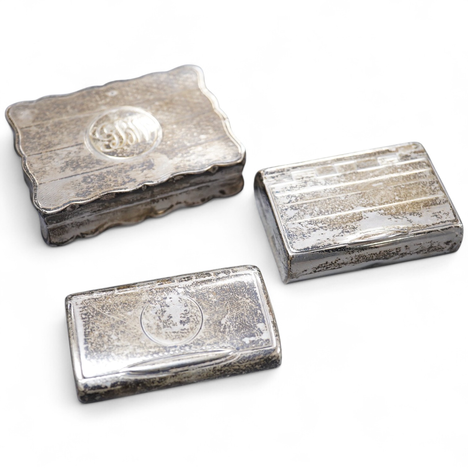 A Victorian silver ovoid snuff box, Henry William Dee, London, 1874, 58mm, together with two George V silver snuff boxes.